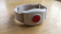 Hausnotruf-Funksender (Armband) gegen Blutdruckmessgerät